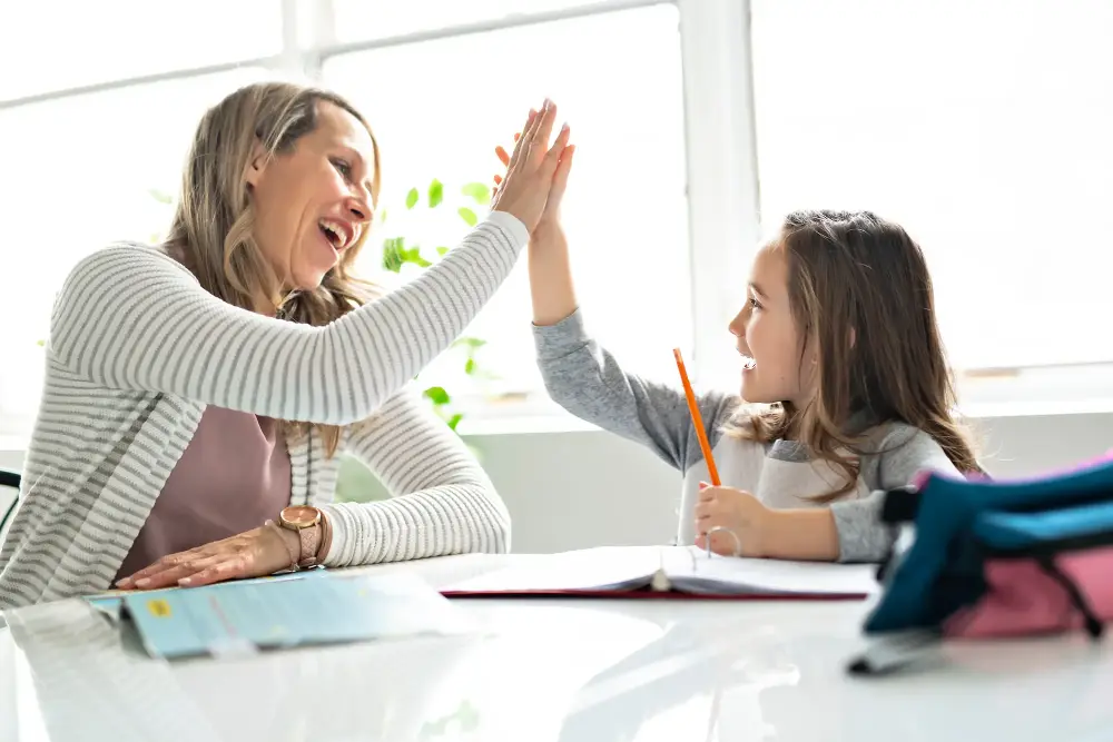 Students raising their hands during homework help